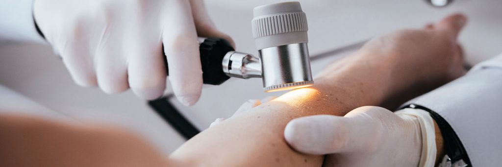 dermatologist performing a skin examination